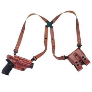 Leather shoulder holster with pistol and pouches.
