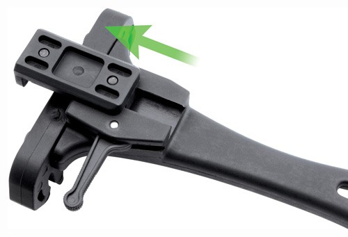 Close-up of black plastic tool with green arrow.