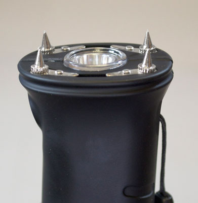 Close-up of black security stun device with spikes.