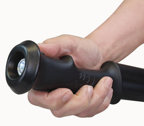 Hand gripping a black flashlight handle