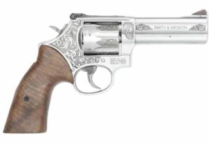 Engraved silver revolver with wooden grip handle.