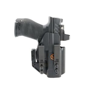 Black pistol holstered with tactical attachments.