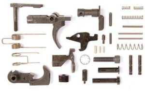 AR-15 lower parts kit components arranged on surface.