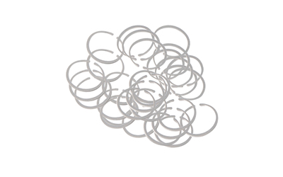Silver wire rings scattered on a white background.