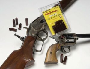 Two antique guns with snap caps and cartridges.