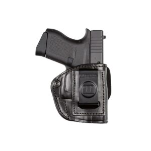 Pistol in black leather holster on white background.