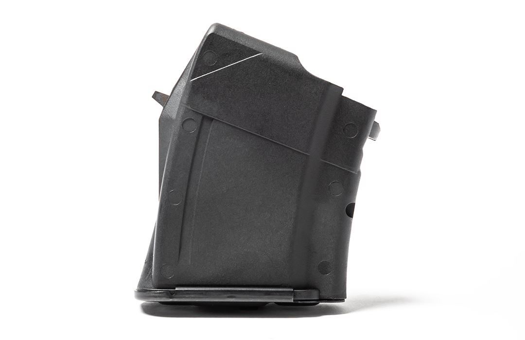 Black firearm magazine on white background