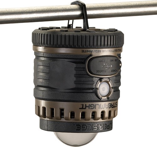 Portable black camping lantern hanging from metal rod