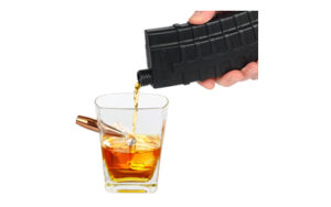 Whiskey poured from black bottle into glass