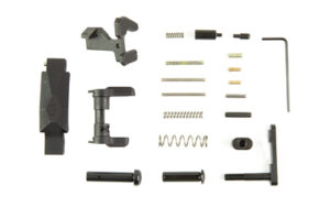 Disassembled firearm components and tools on white background.