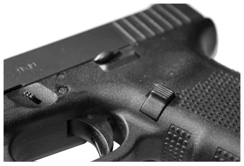 Close-up of a handgun's trigger and grip