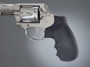 Silver revolver with black grip on gray background