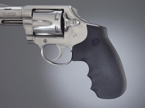 Silver revolver with black grip on gray background