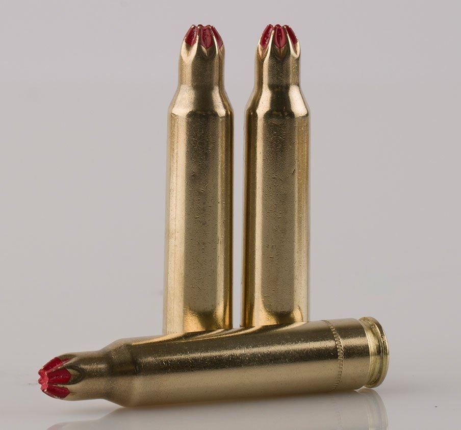 Three gold blank bullet cartridges with red sealant.
