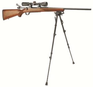 Scoped bolt-action rifle on bipod stand