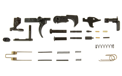 Disassembled firearm trigger assembly parts on white background
