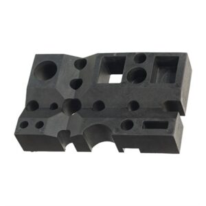 Black rubber block with various holes.