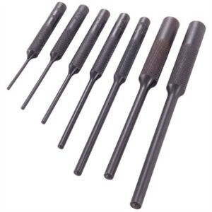 Set of seven black metal punches in row.
