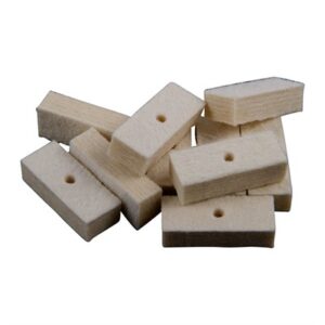 Stacked white felt cleaning pads with holes.