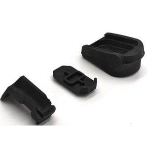 Black plastic clips and components on white surface.