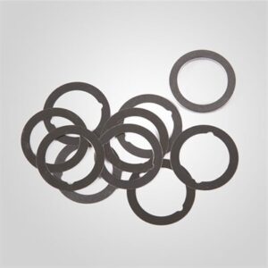 Stack of metal washers on gray background.