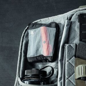 Mesh pouch on gray backpack with water bottle