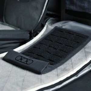 Black pad inside gray tactical backpack.