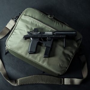 Tactical bag with firearm on dark background.