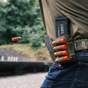 Person with ammunition holster at shooting range