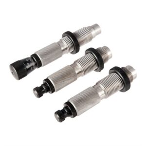 Three metal reloading dies on white background
