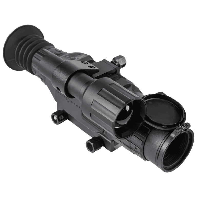 A thermal imaging scope with a matte finish and flip-up lens cover, designed for mounting on rifles. The device features adjustment knobs and a rubber eyepiece, suitable for nighttime or low-visibility conditions. Patriotic Firearms